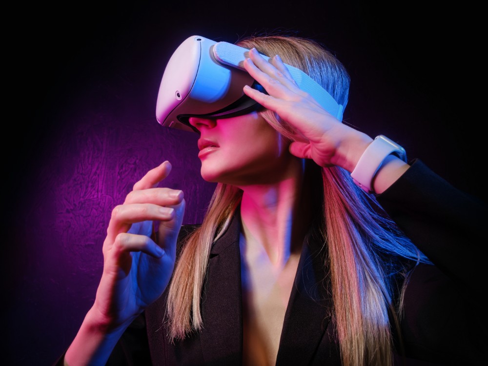 young woman with blond hair vr helmet looks around with surprise delight